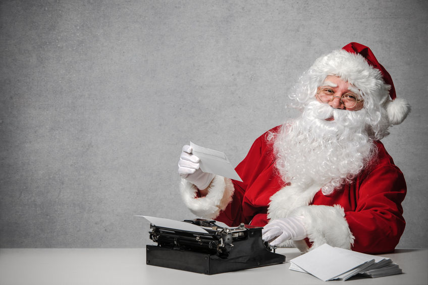 44719392 - santa claus typing a letter on an old typewriter
